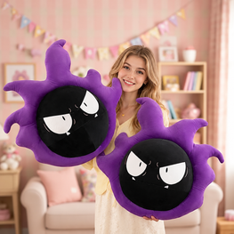 A woman in a cream dress holds two purple and black round plush pillows with cartoon eyes, set against a cozy pink-themed bedroom background.