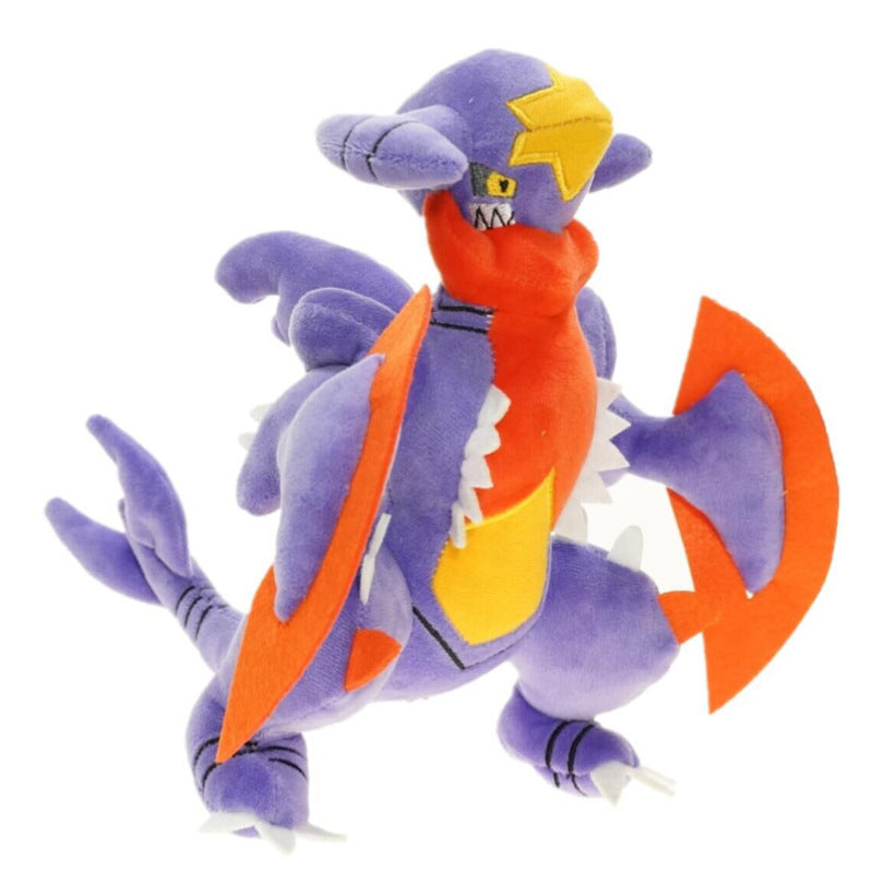 Pokemon Garchomp Plush Toy – Garchomp, Gabite & Gible Stuffed Animal Plush toy of a dragon-like creature with purple, orange, and yellow colors on a white background
