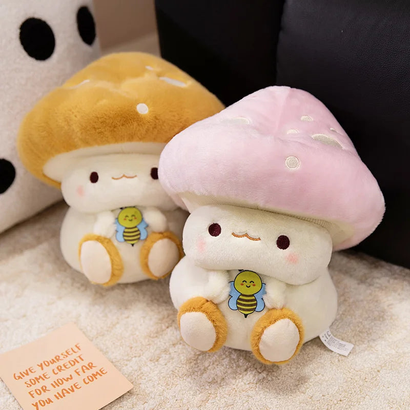 Creative Mushroom Plush Pillow – Cute Stuffed Plant Cushion for Home Décor Two plush mushroom toys with a small card on a textured surface