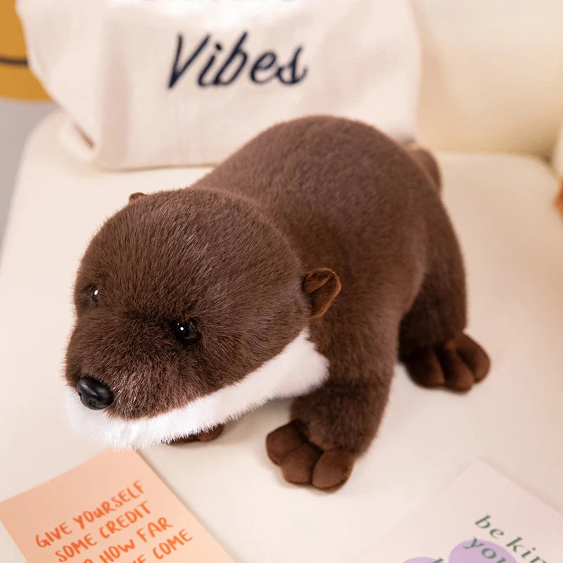 Realistic Otter Plush Toy Plush otter toy on a white surface with a pillow in the background
