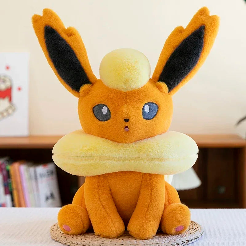 Pokemon Eevee Plush Toy – Vaporeon, Flareon & Jolteon Soft Stuffed Animal Plush toy resembling a character with large ears and a round body on a table.