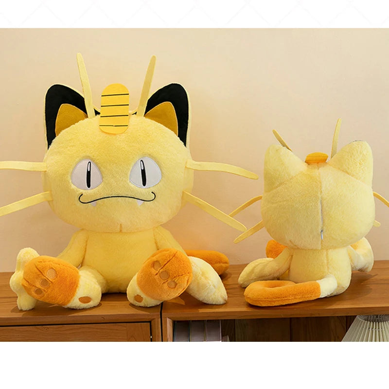 Pokemon Meowth Plush Toy – Giant Cute Stuffed Animal Pillow Two plush toys resembling a cat-like creature with large eyes on a wooden surface.