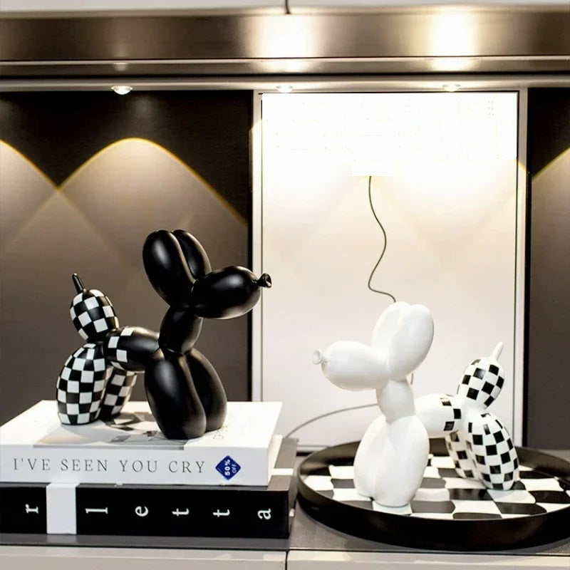 Balloon Dog Sculpture Decor – Cute Animal Home Accent for Living Room Decorative black and white balloon dog sculptures on a shelf with books and a lamp.