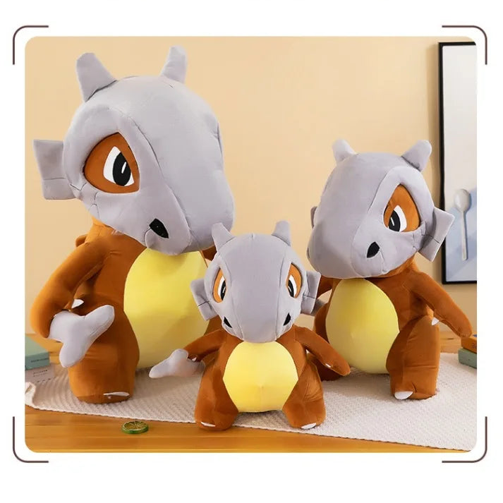 Pokemon Cubone Plush Pillow – Soft Stuffed Animal Three cartoon animal plush toys with gray and brown bodies on a light yellow background.