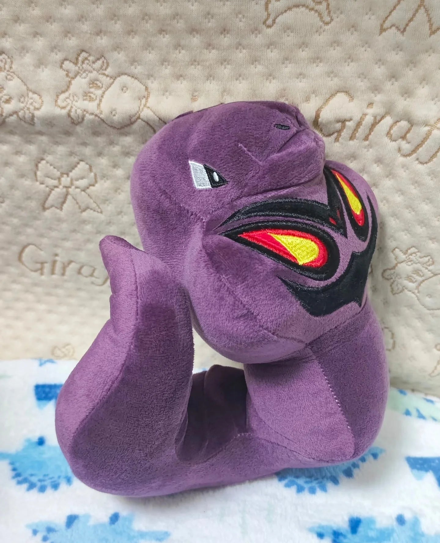 Pokemon Arbok Plush Toy – Ekans Evolution Stuffed Animal Purple plush toy with fiery design on a textured surface