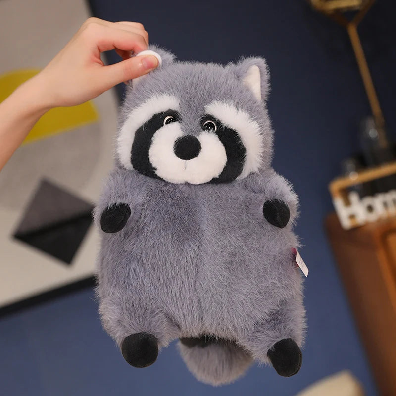 Squishmallow Grey Raccoon Plush Toy Stuffed Animal Plush raccoon toy held by a hand with a blurred background