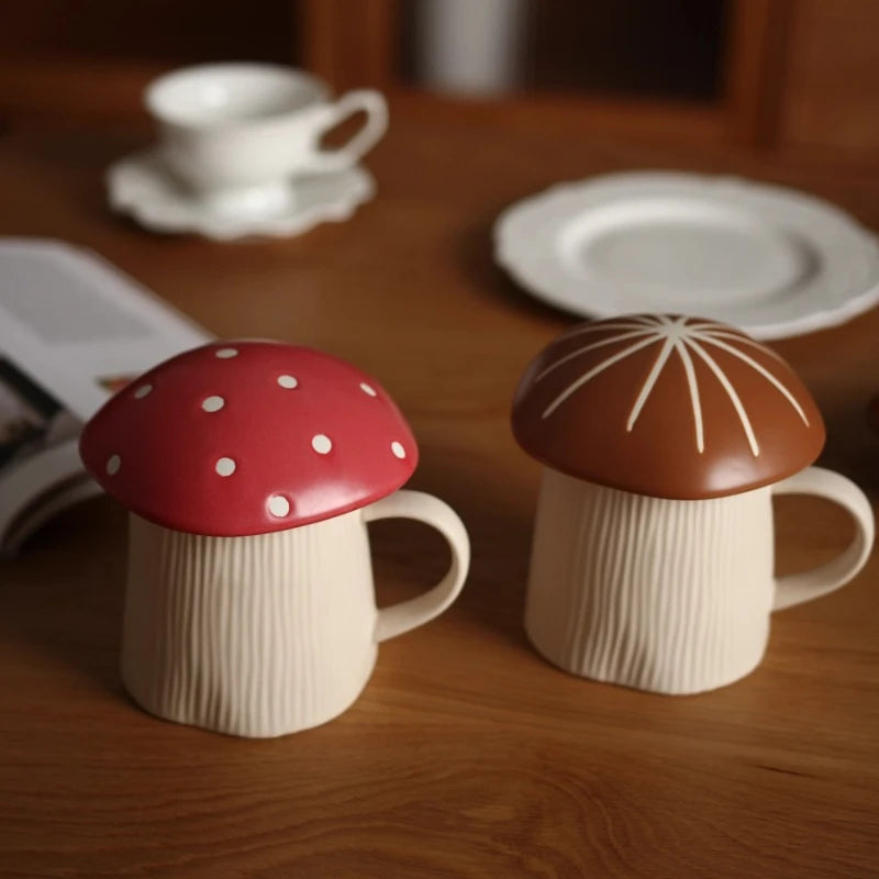 Mushroom Coffee Mug with Lid – Cute Drinking Cup Two ceramic mugs with mushroom-shaped lids on a wooden table.