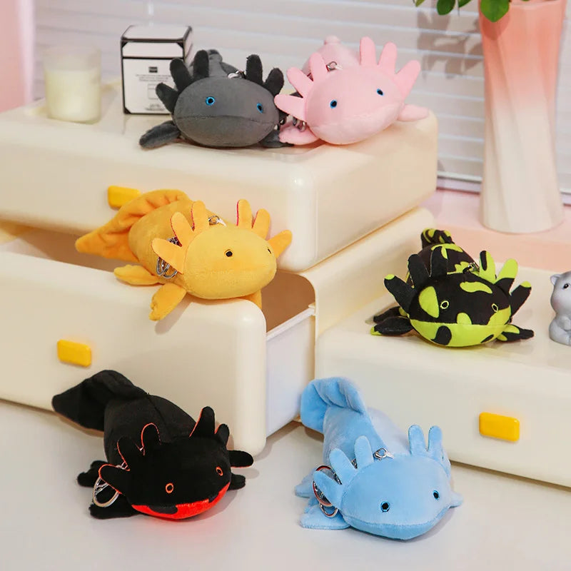 Cute Axolotl Plush Toy – Squishmallow Salamander Stuffed Animal Collection of colorful plush toys on a white surface with a blurred background