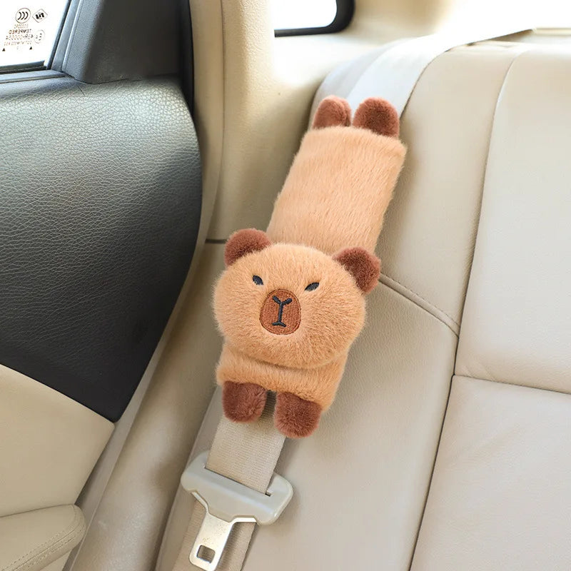 Capybara Car Headrest Neck Pillow & Tissue Holder – Plush Car Decor Teddy bear-shaped car seat safety strap in a vehicle