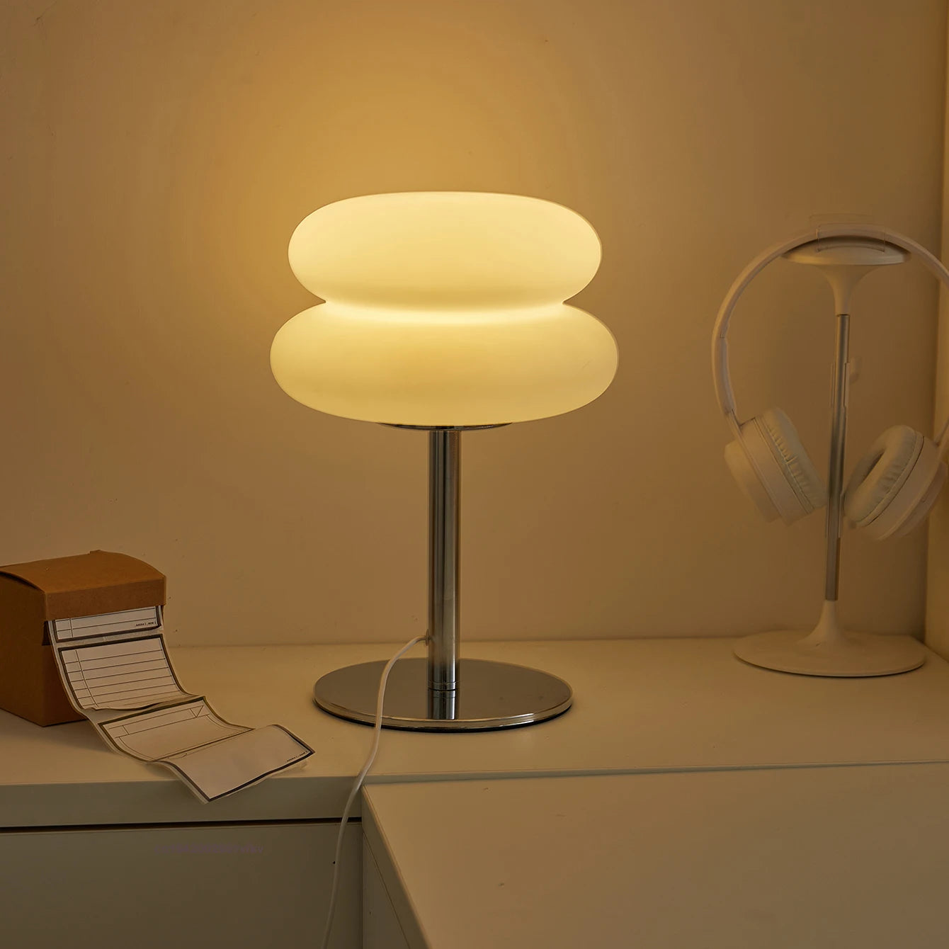 Orange Mushroom Bedside Table Lamp – USB Tri-Color Dimmable Light Modern table lamp with a warm glow on a desk next to a book and headphones.