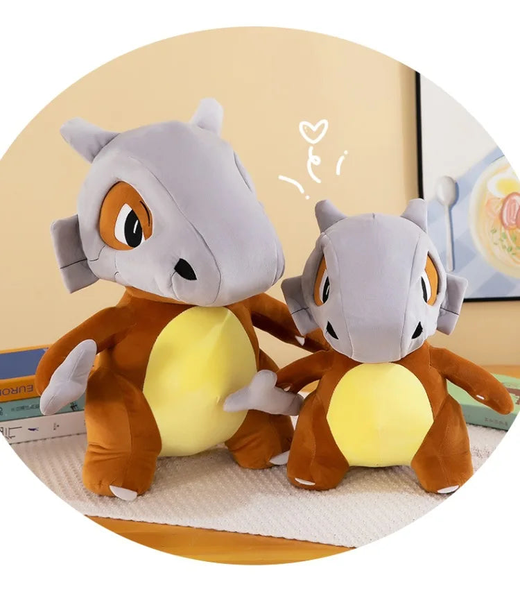 Pokemon Cubone Plush Pillow – Soft Stuffed Animal Two plush toys resembling a cartoon character with a yellow belly and gray head on a light background.