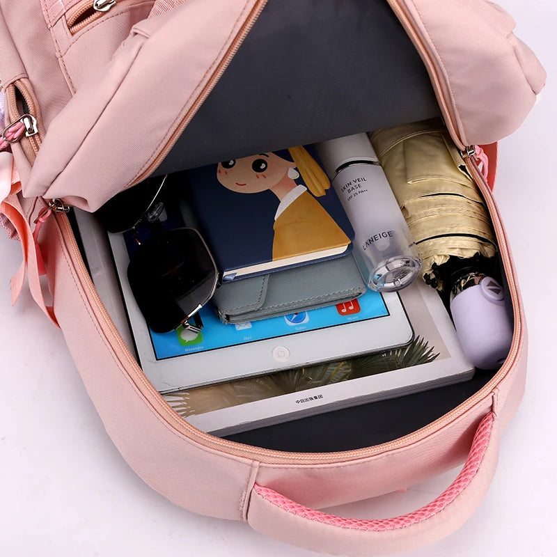 Capybara Bubble Tea Backpack – School Bag for Teens Pink backpack open with tablet, notebook, and other items on a white background
