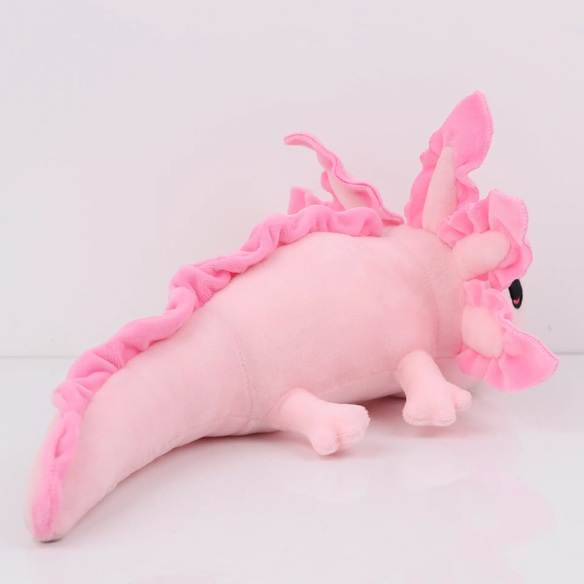 Axolotl Squishmallow Plush Toy – Soft Stuffed Animal Pink plush toy with a frilled texture on a light gray background