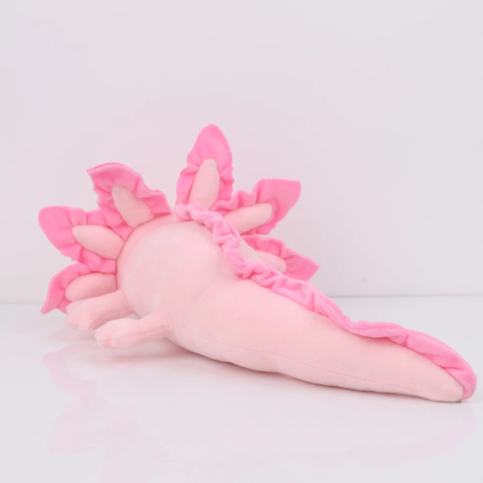 Axolotl Squishmallow Plush Toy – Soft Stuffed Animal Pink plush toy with flower-like design on a light gray background