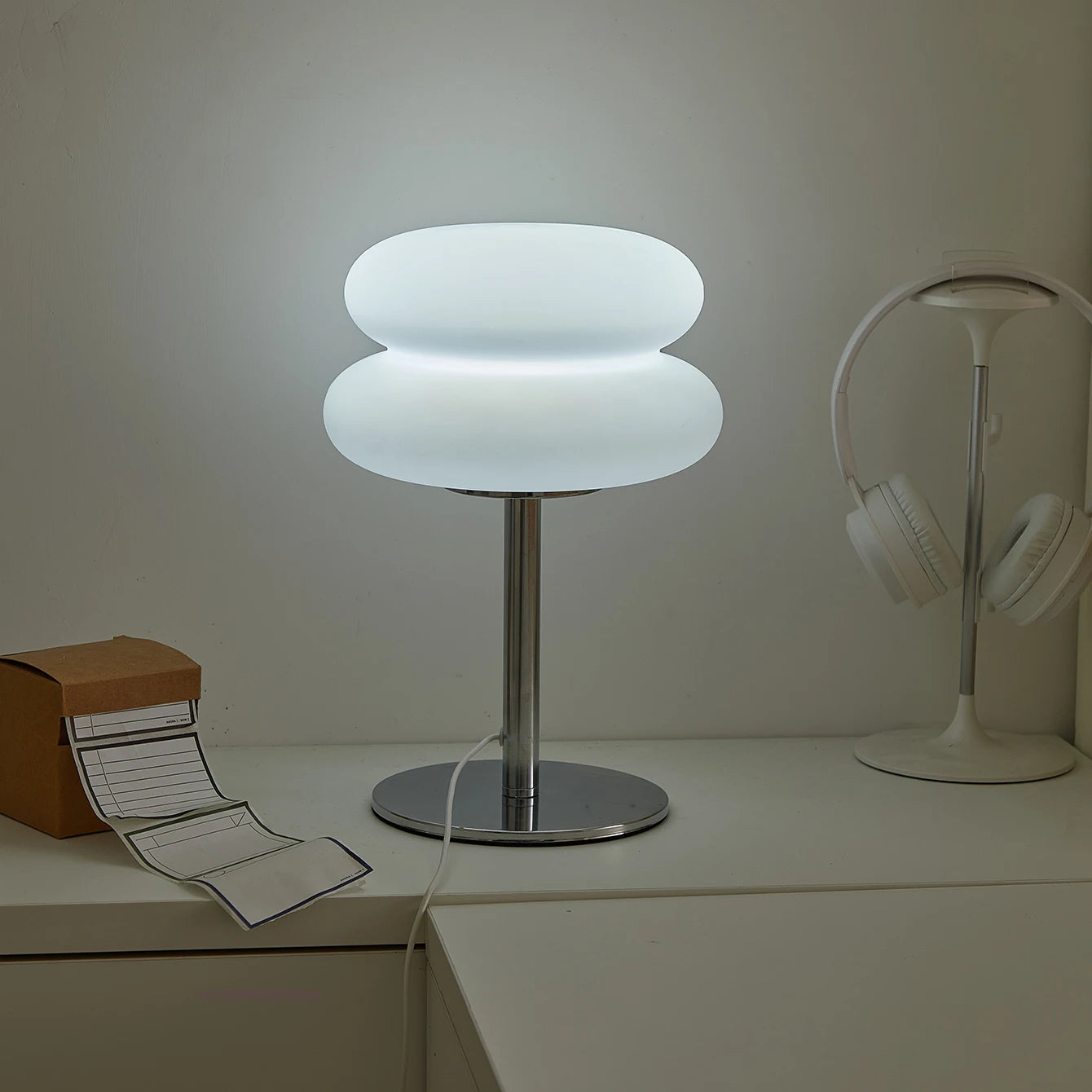 Orange Mushroom Bedside Table Lamp – USB Tri-Color Dimmable Light Modern table lamp with a unique design on a desk next to headphones and a box.