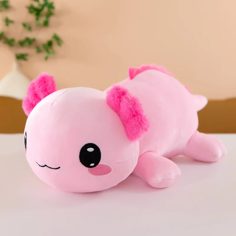Axolotl Squishmallow Plush – Stuffed Animal Toy Pink plush axolotl toy on a light surface with a blurred background