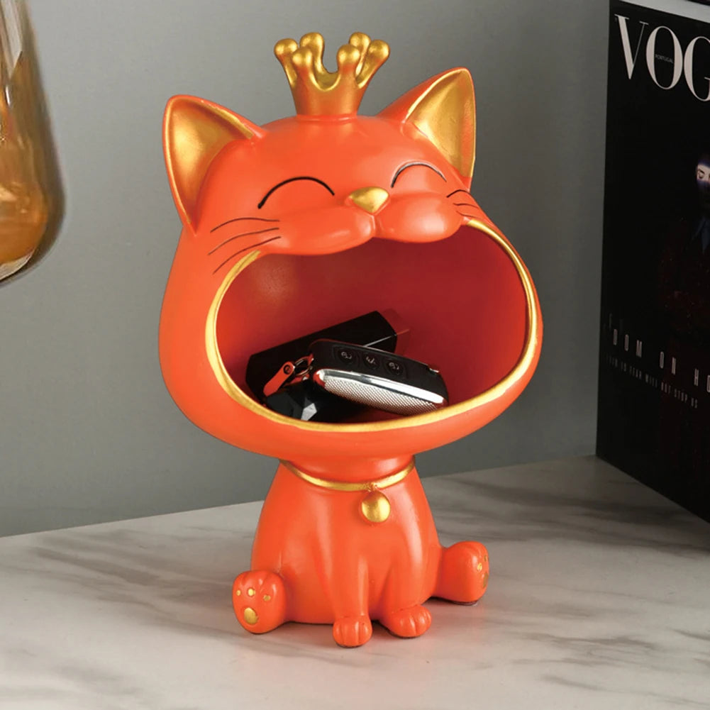 Lucky Cat Figurine with Storage Box – Resin Laughing Cat Home Decor Orange cat-shaped container with a crown on a gray surface