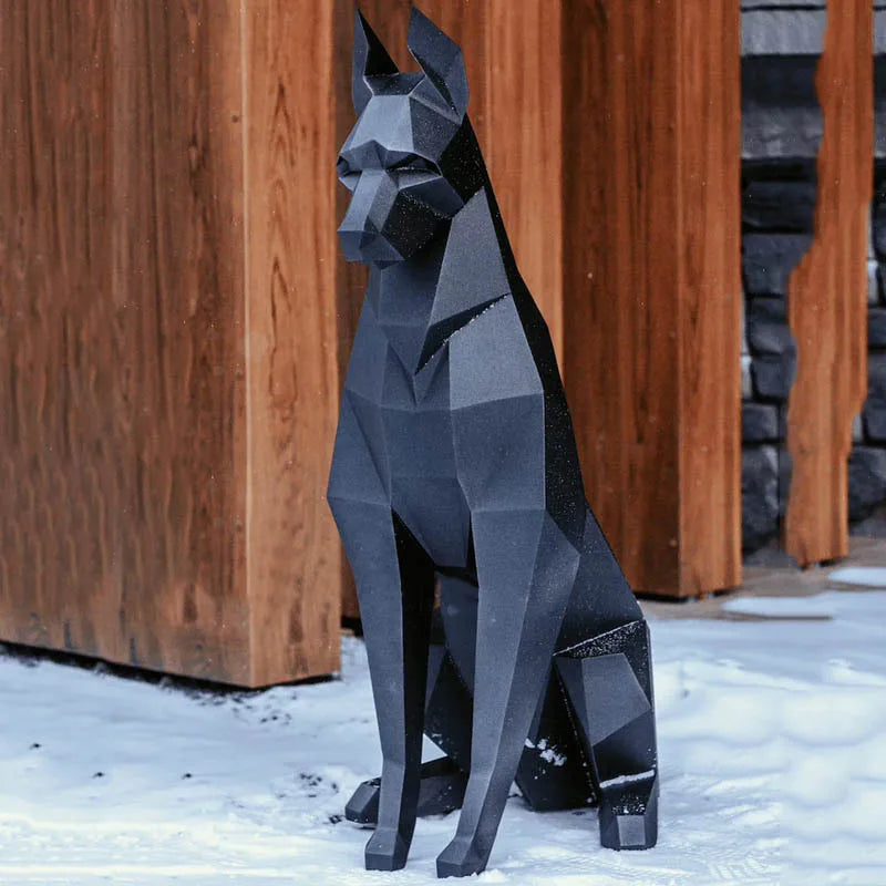 Doberman 3D Paper Model – DIY Animal Papercraft Room Decor Geometric dog sculpture in front of a wooden building with snow on the ground
