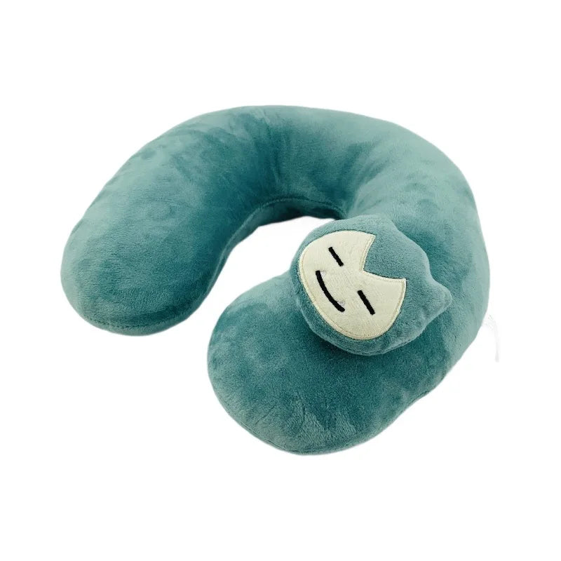Pokemon Furret, Dratini & Snorlax Plush Neck Pillow A plush C-shaped neck pillow in a teal color, featuring a small embroidered character face on the front.