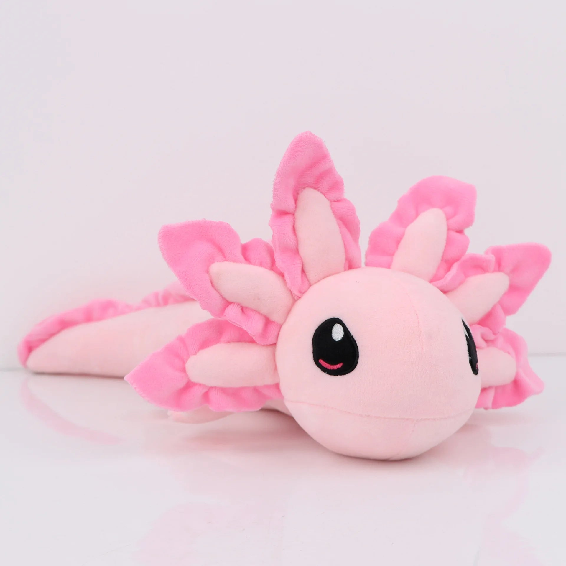 Axolotl Squishmallow Plush Toy – Soft Stuffed Animal Plush axolotl toy with pink wings on a light gray background