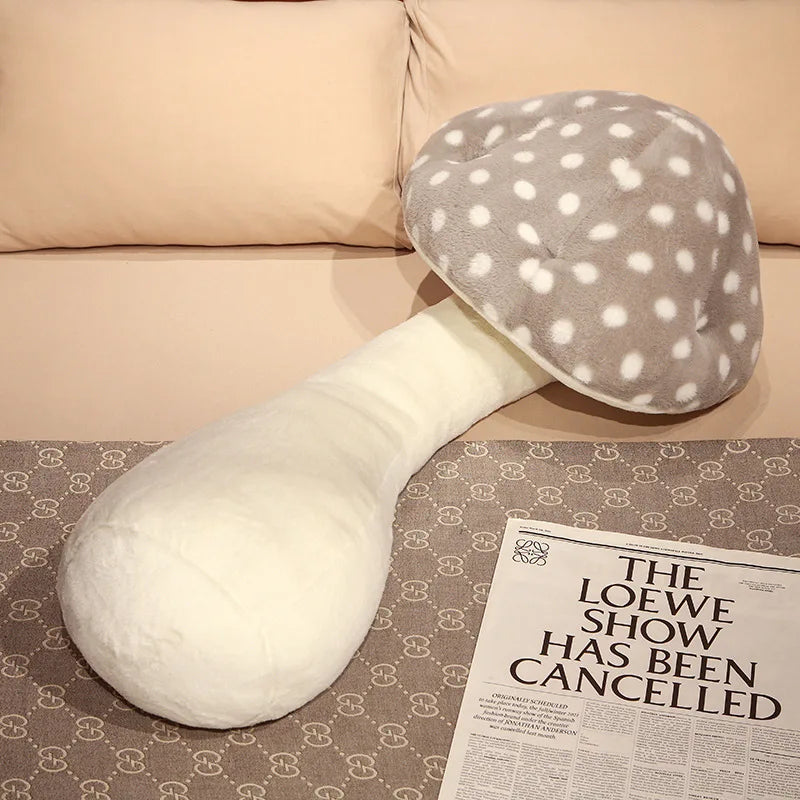 Large Mushroom Plush Pillow – Soft Huggable Stuffed Plant Cushion White U-shaped body pillow with gray polka dot cover on a patterned surface.