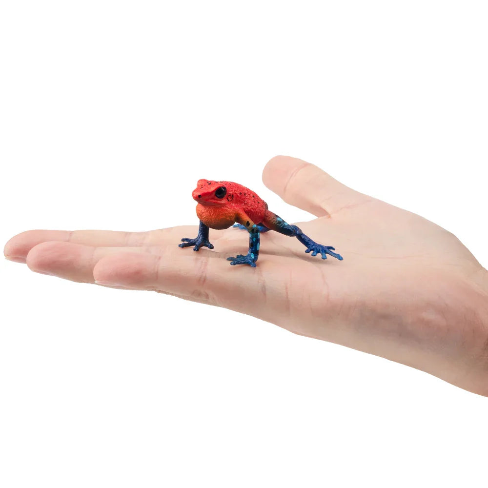 Strawberry Frog Mini Figure – Realistic Animal Model Collectible Toy Small red and blue frog figurine on a person's palm against a white background