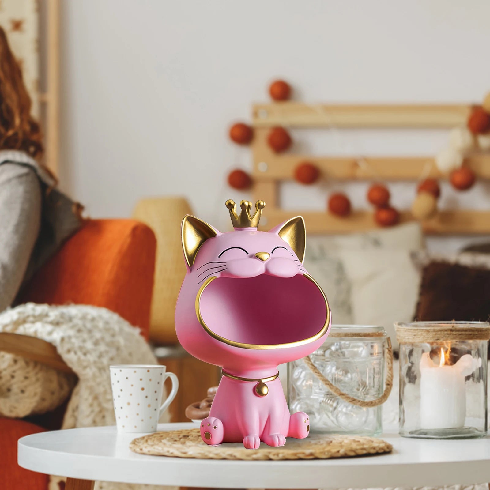Lucky Cat Figurine with Storage Box – Resin Laughing Cat Home Decor Pink cat-shaped lamp with a gold crown on a table in a cozy living room.