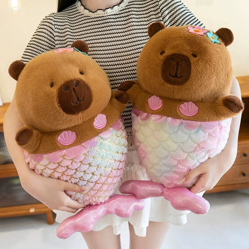 Mermaid Capybara Plush Toy – Cute Kawaii Stuffed Doll Two plush toys resembling mermaid bears held by a person.