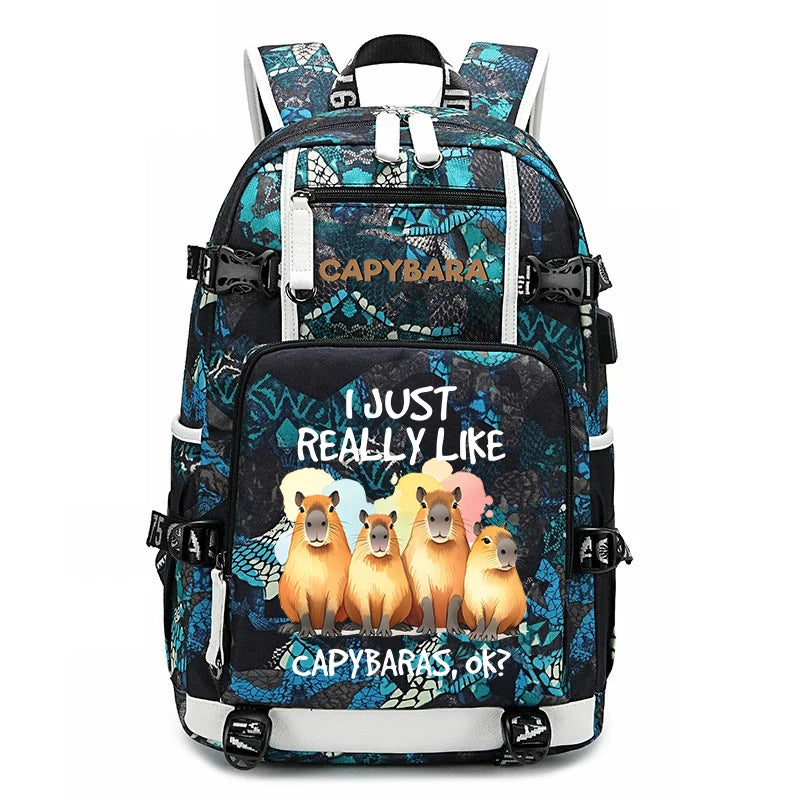 Capybara Backpack – Large Capacity Lightweight School Bag A backpack featuring a black and teal patterned design with a front graphic of four capybaras and the text 'I JUST REALLY LIKE CAPYBARAS ok?'. The brand name 'Capybara' is printed on the upper front pocket.