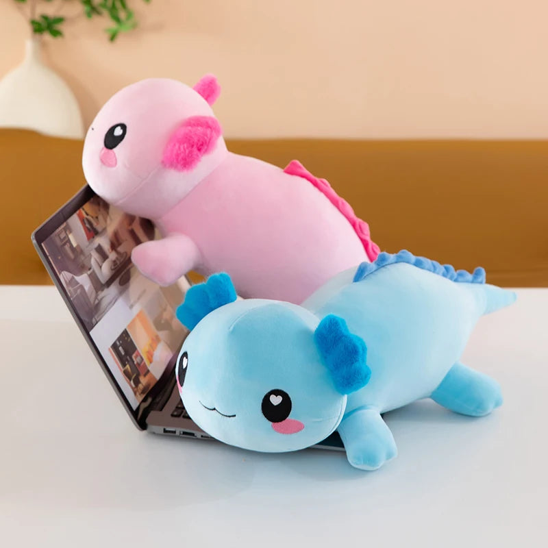Axolotl Squishmallow Plush – Stuffed Animal Toy Two plush toys, one pink and one blue, sitting on a laptop.