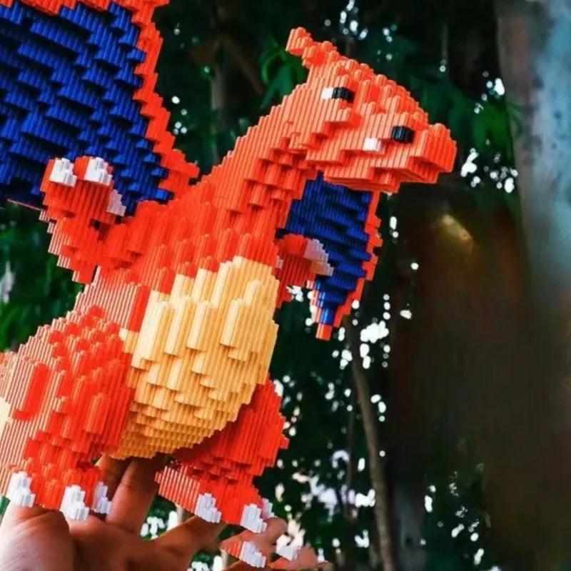 Pokemon Fire-Breathing Dragon Building Blocks – Model Brick Toy Hand holding a colorful dragon-like creature made of interlocking bricks against a blurred natural background.