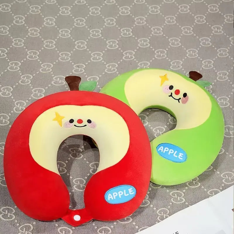 Cute Capybara U-Shaped Neck Pillow – Plush Travel Pillow Two plush apple-shaped neck pillows on a patterned gray background. One is red with a cream center and a small brown stem, and the other is green with a cream center and a small brown stem.