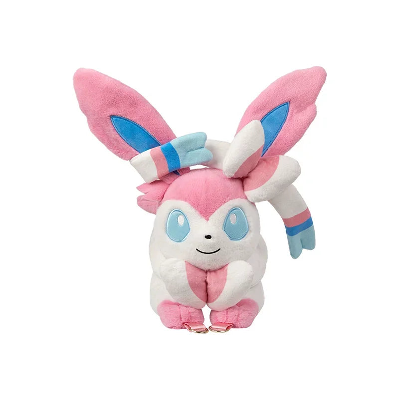 Pokemon Eevee Evolution Plush Crossbody Bag A pink and white plush toy resembling a cute bunny or fox character with large pink ears, blue inner ear accents, light blue eyes, and small blue and pink striped details, shown on a plain white background.