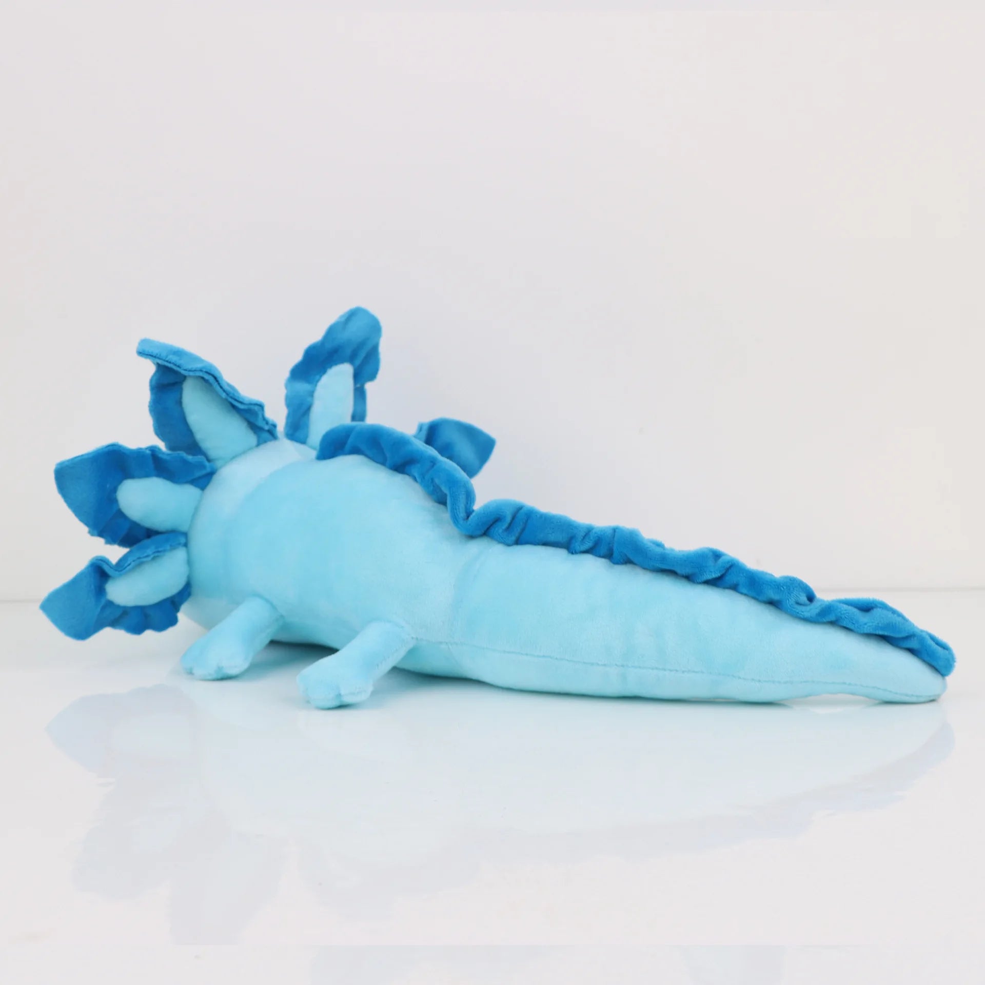Axolotl Squishmallow Plush Toy – Soft Stuffed Animal Blue plush toy resembling a dragon on a light gray background