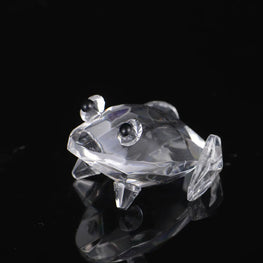 Crystal frog figurine on a black background