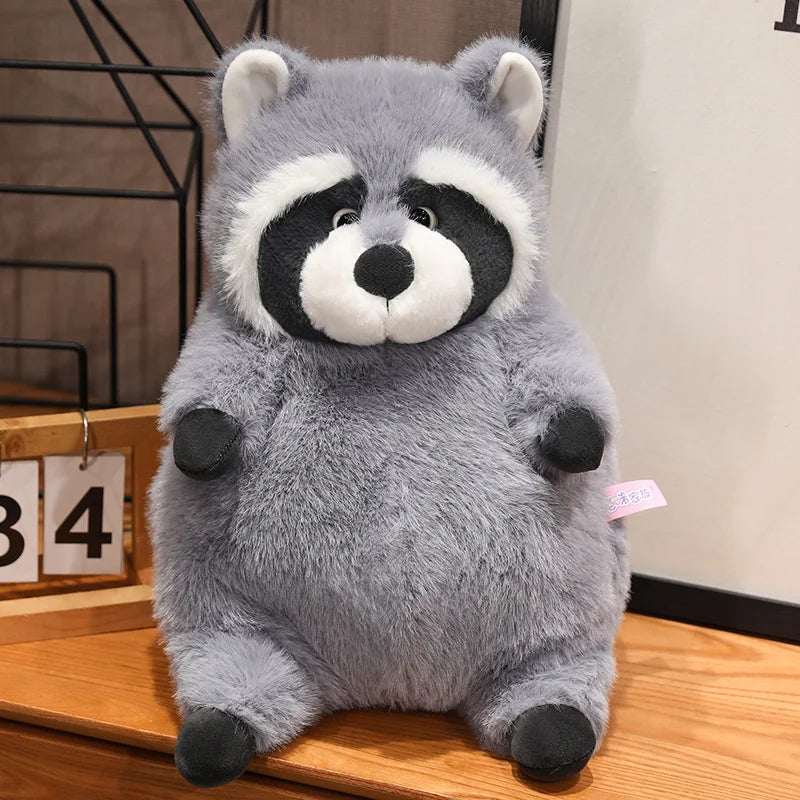 Squishmallow Grey Raccoon Plush Toy Stuffed Animal Plush raccoon toy on a wooden surface with a neutral background