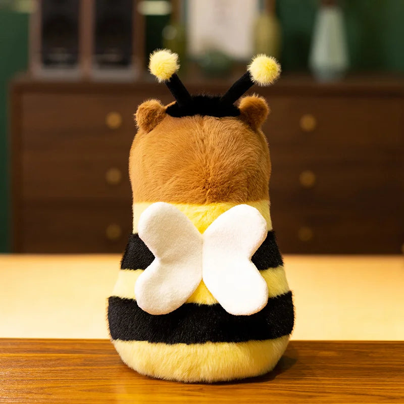 Bee Capybara Plush Toy – Kawaii Soft Stuffed Animal Plush toy shaped like a bee on a wooden surface with a blurred background
