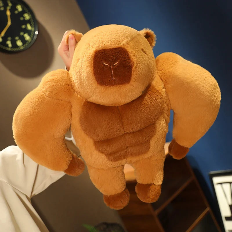 Muscle Capybara Plush Pillow – Funny Brown Stuffed Animal Cushion Plush toy bear with a muscular build held by a person indoors.