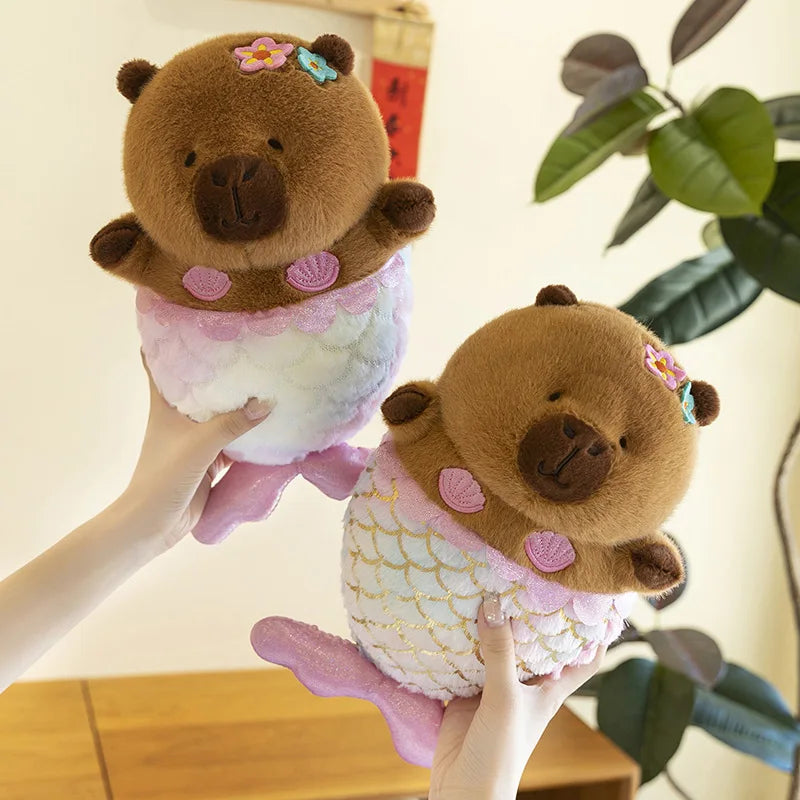 Mermaid Capybara Plush Toy – Cute Kawaii Stuffed Doll Two plush mermaid bears held by a hand with a blurred indoor background