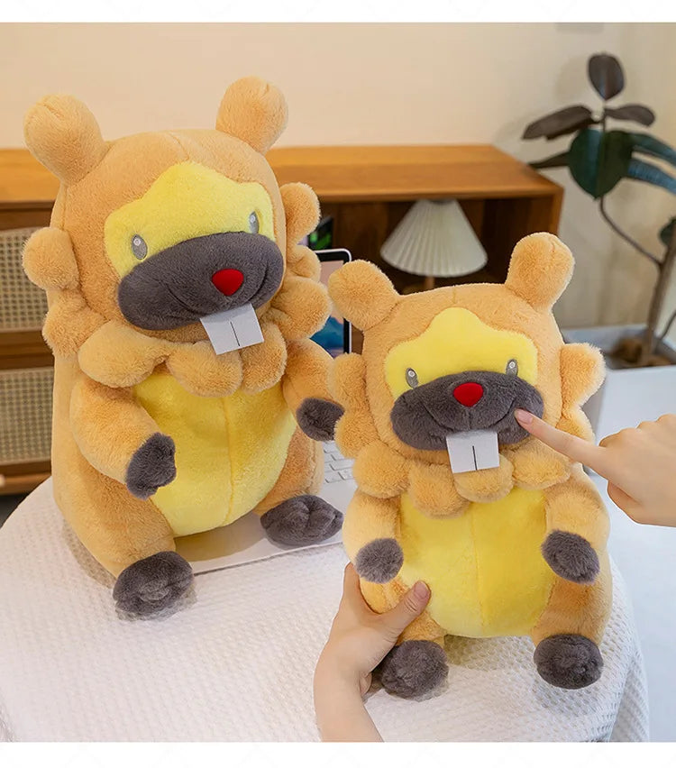 Pokemon Bidoof Plush Toy – Cute Sleeping Stuffed Animal Pillow Two plush toys resembling a lion and a bear on a white surface with a blurred background.