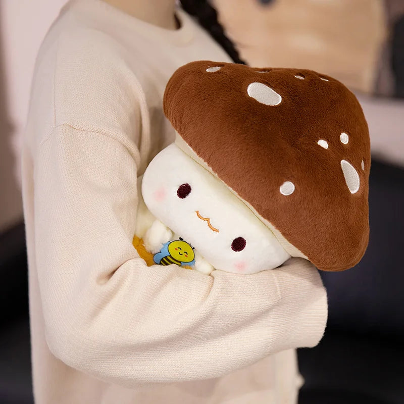 Creative Mushroom Plush Pillow – Cute Stuffed Plant Cushion for Home Décor Person holding a plush toy resembling a cartoon mushroom with a small character inside.