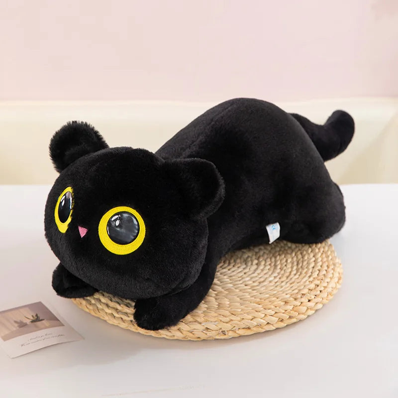 Black Cat Plush Pillow – Cute Kawaii Stuffed Animal Cushion Black plush toy with large eyes on a woven mat