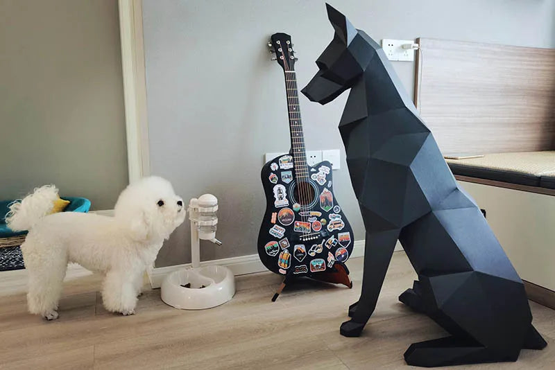 Doberman 3D Paper Model – DIY Animal Papercraft Room Decor White dog standing next to a black geometric dog sculpture in a room with a guitar and mirror.