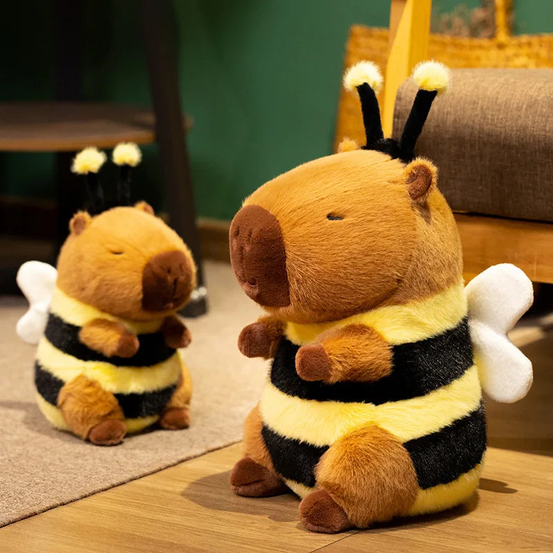 Bee Capybara Plush Toy – Kawaii Soft Stuffed Animal Two plush bee toys on a wooden floor with a blurred background
