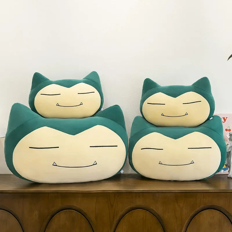 Pokemon Snorlax Plush Pillow – Cute Oversized Stuffed Animal Two Snorlax plush toys on a wooden surface with a white background