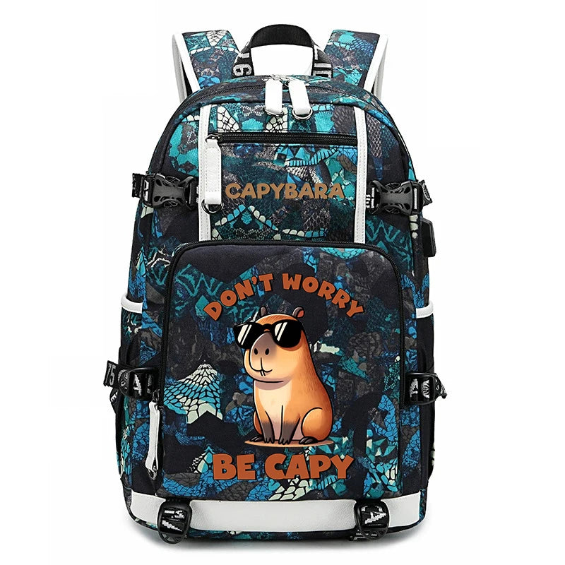 Capybara Backpack – Large Capacity Lightweight School Bag A backpack with a blue and black patterned design, featuring a cartoon capybara wearing sunglasses on the front pocket with the text 'DON'T WORRY BE CAPY' and 'Capybara' printed on the upper compartment.