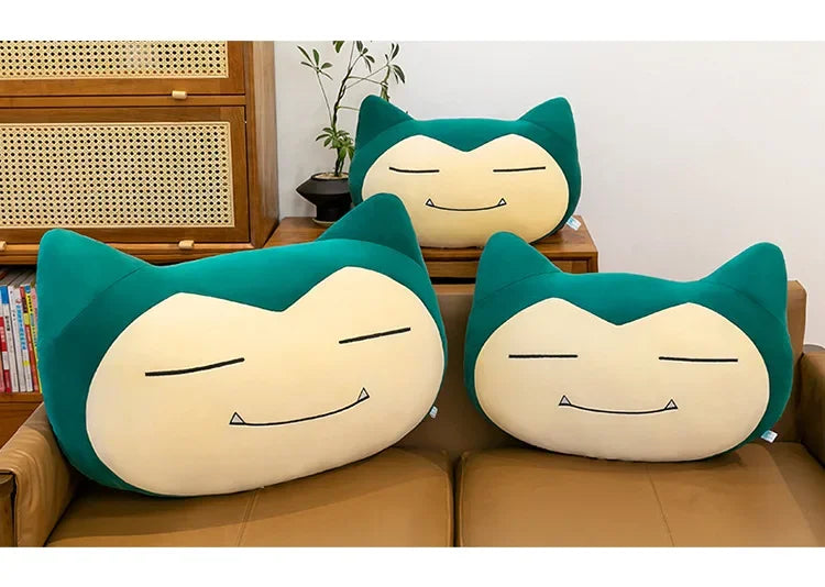 Pokemon Snorlax Plush Pillow – Cute Oversized Stuffed Animal Three Snorlax plush toys on a couch in a living room setting.