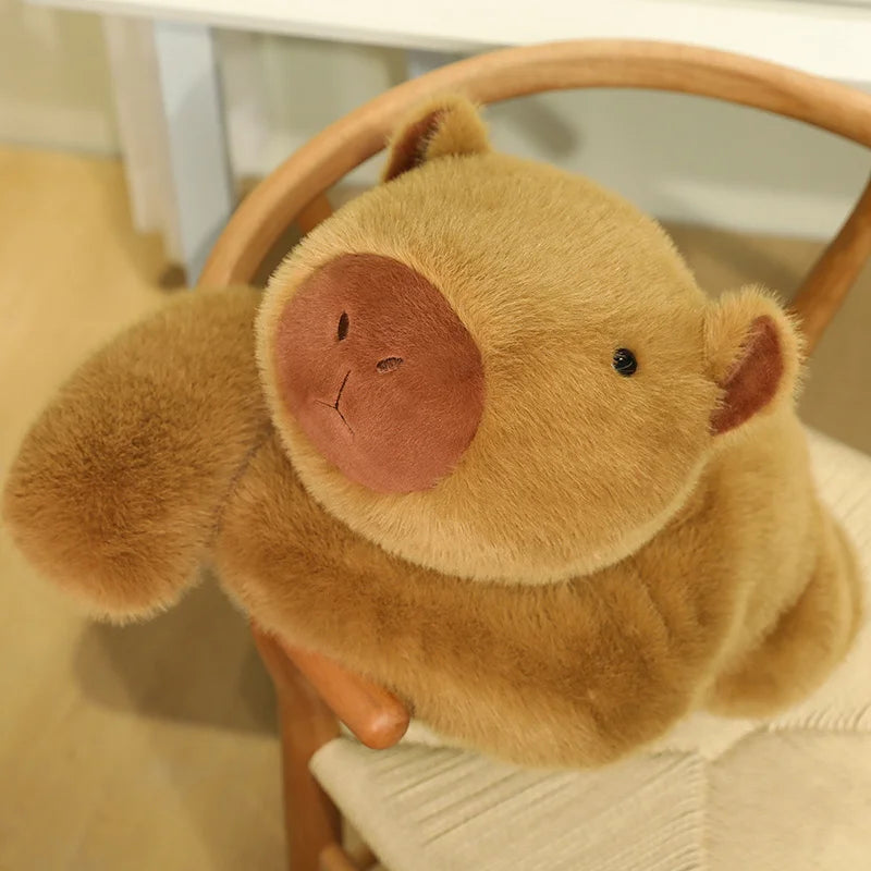 Weighted Capybara Plush Pillow – Soft Stuffed Animal Brown teddy bear sitting on a chair with a blurred background