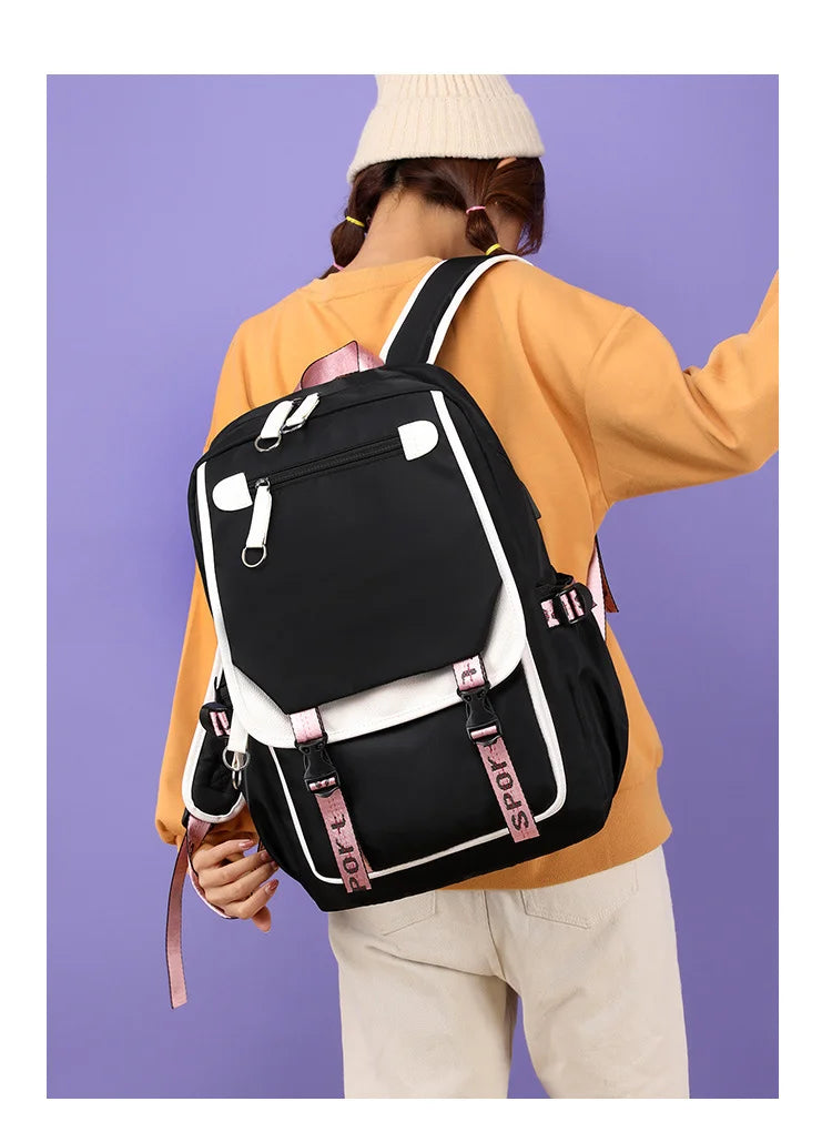 Axolotl Backpack – Anime Pattern USB School & Travel Bag Person wearing a black and white backpack with pink accents on a purple background