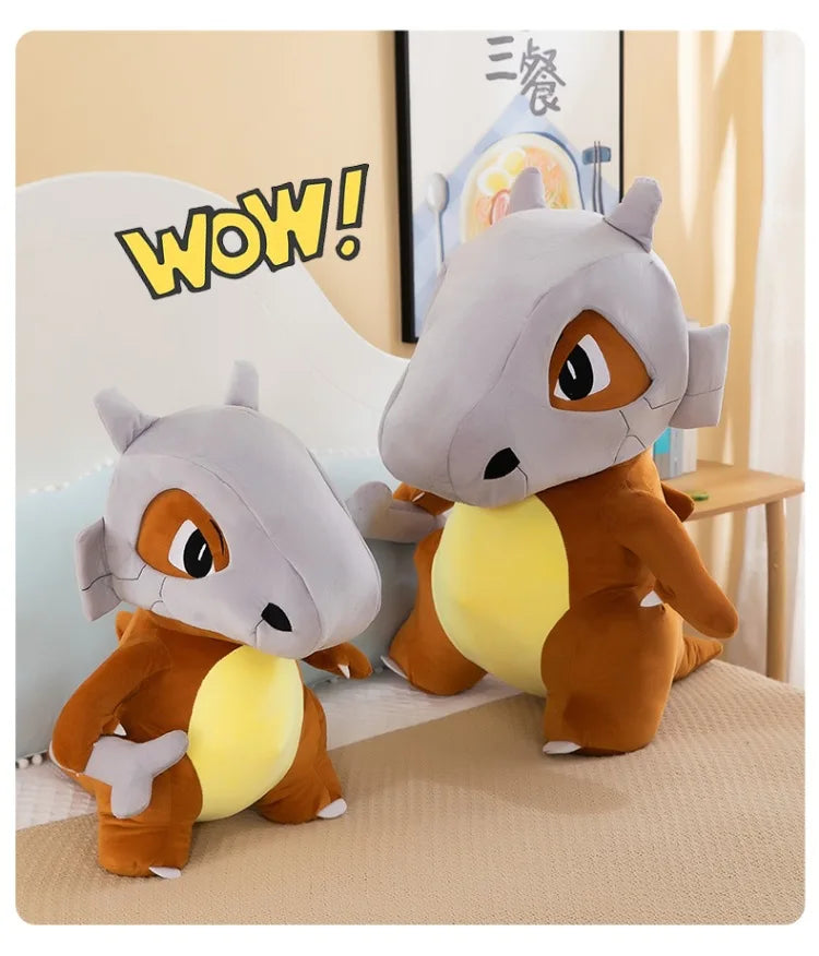 Pokemon Cubone Plush Pillow – Soft Stuffed Animal Two cartoon animal plush toys on a bed with a 'WOW!' graphic in the background.